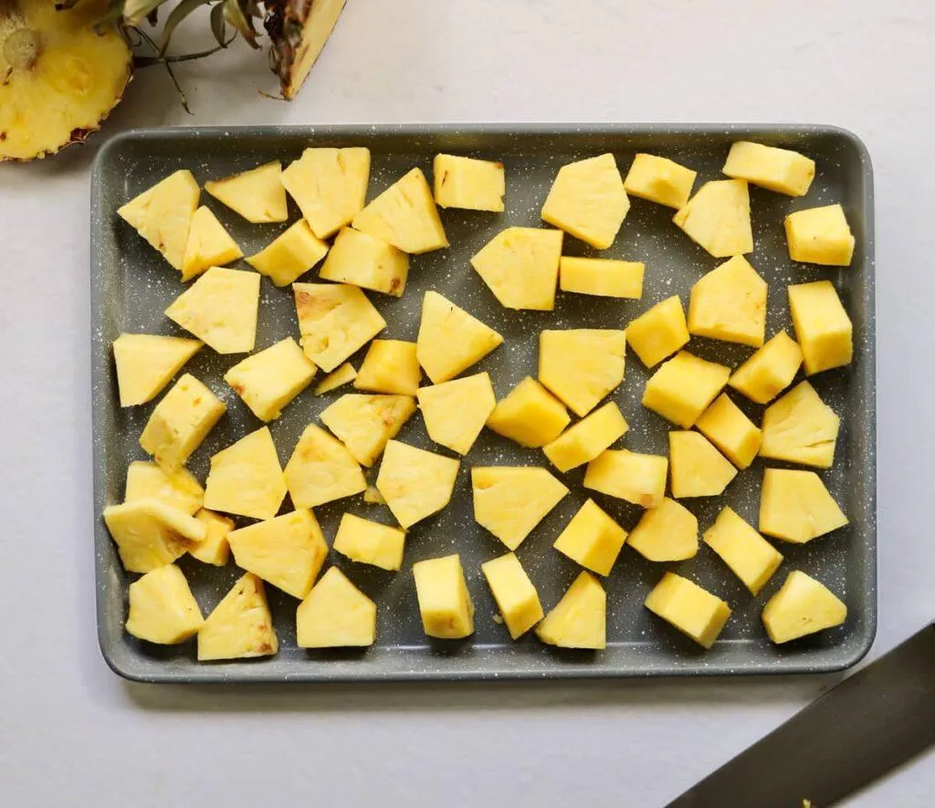 flash freezing pineapple on baking sheet