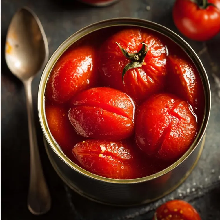 Opened can of whole peeled tomatoes in thick, deep red puree with glossy surfaces and visible seeds